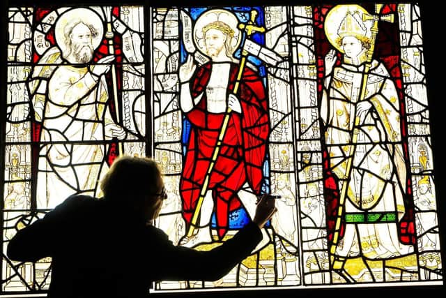 Conservator Keith Barley MBE works on large stained glass windows from All Saints North Street Church at Barley Studio in York. Image: Danny Lawson/PA Wire