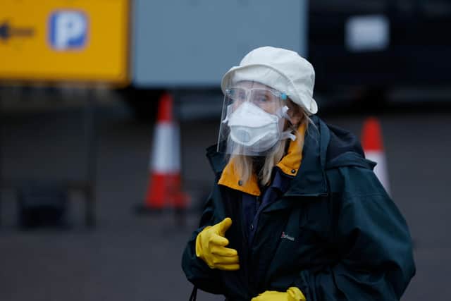 A woman wearing PPE arrives at a Covid vaccine centre this week.