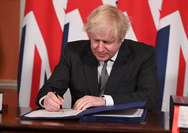 Prime Minister Boris Johnson signs the EU-UK Trade and Cooperation Agreement on December 30.