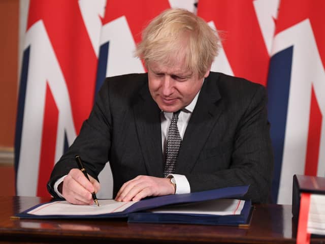 Prime Minister Boris Johnson signs the EU-UK Trade and Cooperation Agreement on December 30.