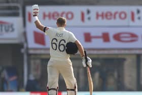 Hero: An appropriate backdrop as England captain Joe Root salutes his century on his 100th Test appearance in the first Test against India in Chennai. (Picture: Pankaj Nangia/Sportzpics for BCCI)