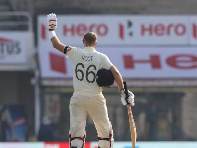 Hero: An appropriate backdrop as England captain Joe Root salutes his century on his 100th Test appearance in the first Test against India in Chennai. (Picture: Pankaj Nangia/Sportzpics for BCCI)