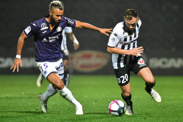 John Bostock, left, in action for Toulouse, battling against Angers' midfielder Flavien Tait back in 2018. Picture: JEAN-FRANCOIS MONIER/AFP via Getty Images