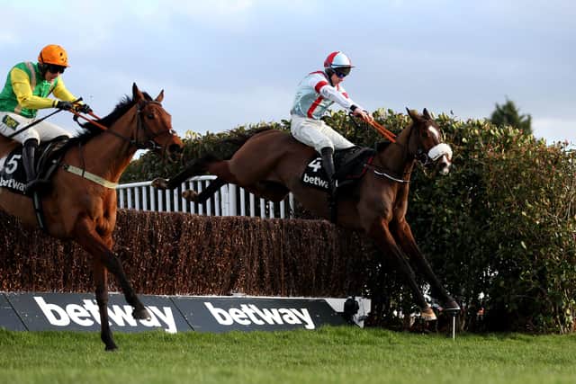 Itchy Feet (right) reverts to smaller obstacles in today's Cleeve Hurdle - weather permitting - after denying Sue Smith's Midnight Shadow in last year's Henry VIII Novices Chase at Sandown.