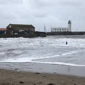 The man, in a wetsuit, was in the sea near the lifeboat station.