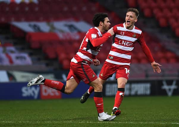 Doncaster's Jon Taylor celebrates his opening goal with Matt Smith.  Pictures: Jonathan Gawthorpe