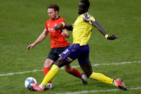 Point-saver: Luton Town's Jordan Clark and Huddersfield Town scorer Naby Sarr battle for the ball.