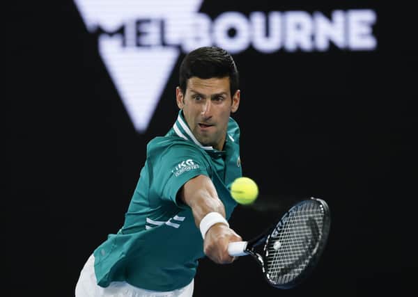 ON SONG: Serbia's Novak Djokovic makes a backhand return to France's Jeremy Chardy during their first round match at the Australian Open in Melbourne. Picture: AP/Rick Rycroft