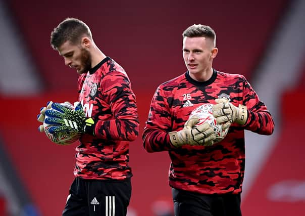 Manchester United goalkeeper Dean Henderson, right, warming up with No keeper David de Geaa. Picture: Laurence Griffiths/PA