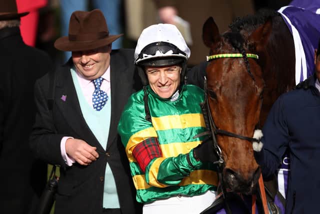 All smiles: Champ with trainer Nicky Hnderson, left and former jockey Barry Geraghty following victory in the the RSA Insurance Novices' Chase. Picture: Tim Goode/PA Wire.