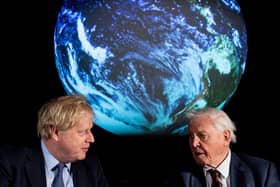 Boris Johnson (L) and British broadcaster and naturalist Sir David Attenborough speak during the launch of the UK-hosted COP26 UN Climate Summit.