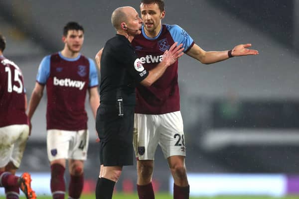 WRONG CALL: West Ham's Tomas Soucek (right) reacts after being shown a red card by Mike Dean. The Premier League referee and his family received death threats following the sending off against Fulham at the weekend. Picture: Clive Rose/PA.