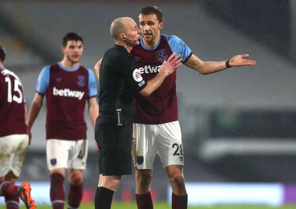 WRONG CALL: West Ham's Tomas Soucek (right) reacts after being shown a red card by Mike Dean. The Premier League referee and his family received death threats following the sending off against Fulham at the weekend. Picture: Clive Rose/PA.