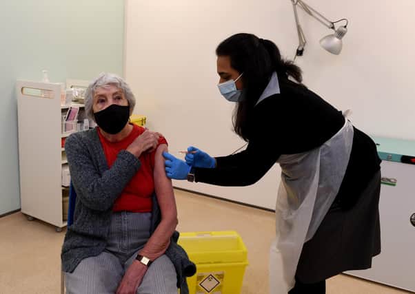 A patient is vaccinated at the Boots pharmacy in Halifax, one of the first in the country to offer Covid jabs.