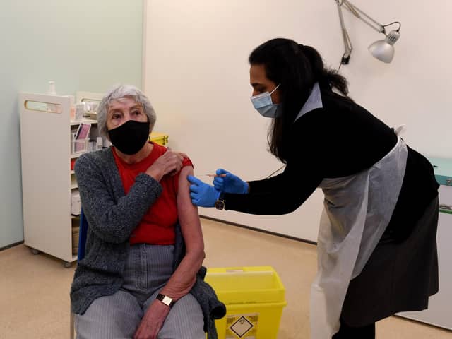 A patient is vaccinated at the Boots pharmacy in Halifax, one of the first in the country to offer Covid jabs.