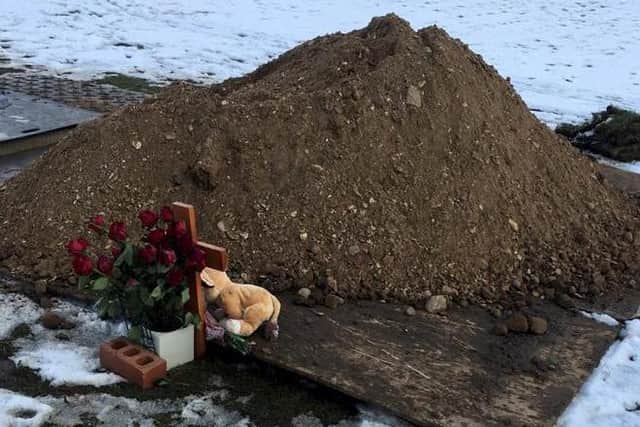 Oliver's teddy was tossed to the side of the grave (photo: SWNS)