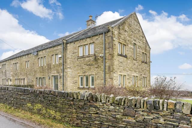 Cop Hill Side, Slaithwaite, is a four-bedroom farmhouse for sale at £600,000 with www.fineandcountry.com