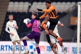 Got it: Hull City's Mallik Wilks challenges Milton Keynes Dons goalkeeper Andy Fisher. Picture: PA