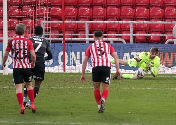 Make it a double: Sunderland goalkeeper Lee Burge saves the second Doncaster Rovers penalty against him.