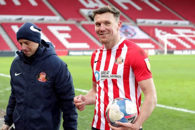Match-winner: Sunderland's Charlie Wyke leaves the pitch with the match ball.