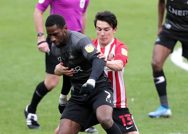 Sunderland's Luke O'Nien (right) and Doncaster Rovers' Omar Bogle battle for the ball. Picture: PA.