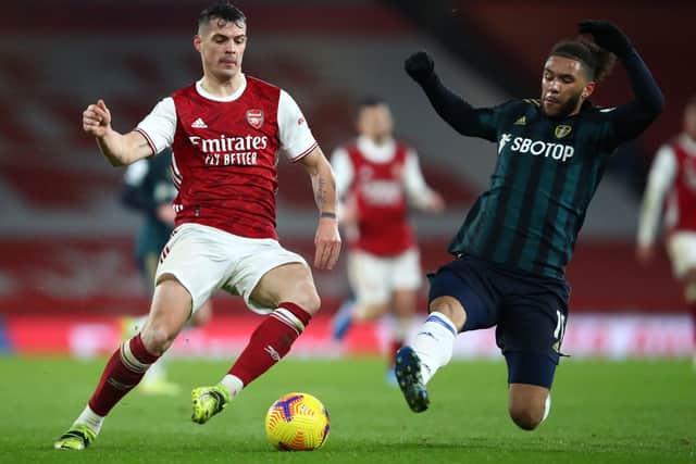 Arsenal's Granit Xhaka (left) and Leeds United's Tyler Roberts battle for the ball.