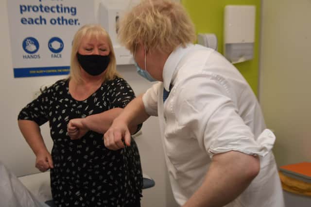 Prime Minister Boris Johnson meets Lynne Powrie during a visit to a coronavirus vaccination centre yesterday.