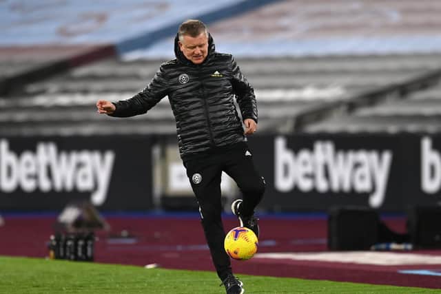 STILL GOT IT: Sheffield United manager Chris Wilder kicks the ball back in to play at the London Stadium. Picture: Glyn Kirk/PA