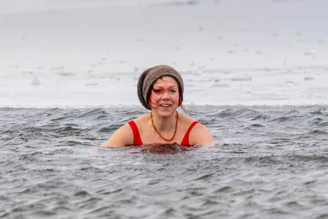 Groups of adventurous cold water swimmers daily visit Gaddings Dam, located on top of the moors between Todmorden and Walsden in West Yorkshire. Pictured Jamima Latimer,  who has set up a company caled 'Swim Feral' from Todmorden, taking her daily visit to this out-door cold water swimming site. Picture: James Hardisty