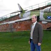 Auctioneer Andrew Baitson by the Hawker Hunter at Fort Paull near Hull