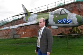 Auctioneer Andrew Baitson by the Hawker Hunter at Fort Paull near Hull