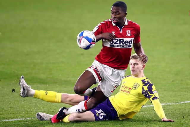 Getting stuck in: Huddersfield Town's Kieran Phillips tackles Middlesbrough's Anfernee Dijksteel.