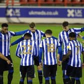 Sheffield Wednesday players, including Liam Shaw and Barry Bannan, are pictured in a pre-match huddle.