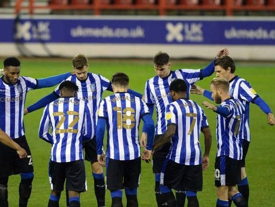 Sheffield Wednesday players, including Liam Shaw and Barry Bannan, are pictured in a pre-match huddle.