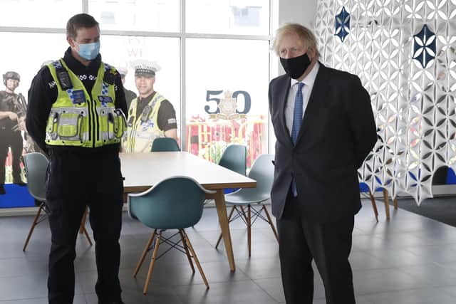 Prime minister Boris Johnson (centre) meets police officers during a visit to South Wales Police Headquarters in Bridgend.