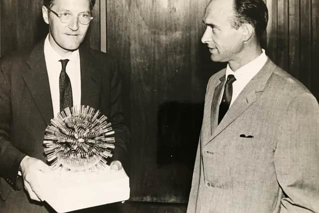 Prof.  Tony Waterson, left, a leading authority on viruses, holding a virus model with Prof Rudi Rott of Germany in the mid 1960s. They worked together on research.