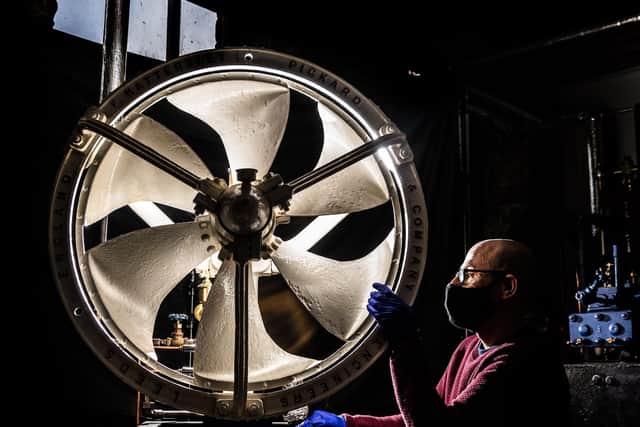 John McGoldrick, curator of Industrial History for Leeds Museums and Galleries, inspects a working Steam Powered Fan, from Holbeck's Hattersley, Pickard & Co. PIC: James Hardisty