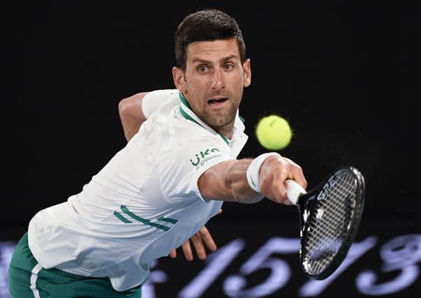 Into final: Serbia's Novak Djokovic hits a backhand return to Russia's Aslan Karatsev.
