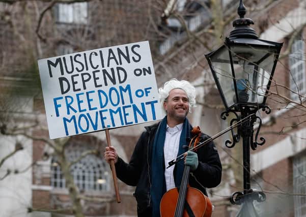 British-German musician Simon Wallfisch poses with his cello outside Europe House in London on January 10, 2019 before his monthly musical performance to protest against Britain's exit from the European Union.