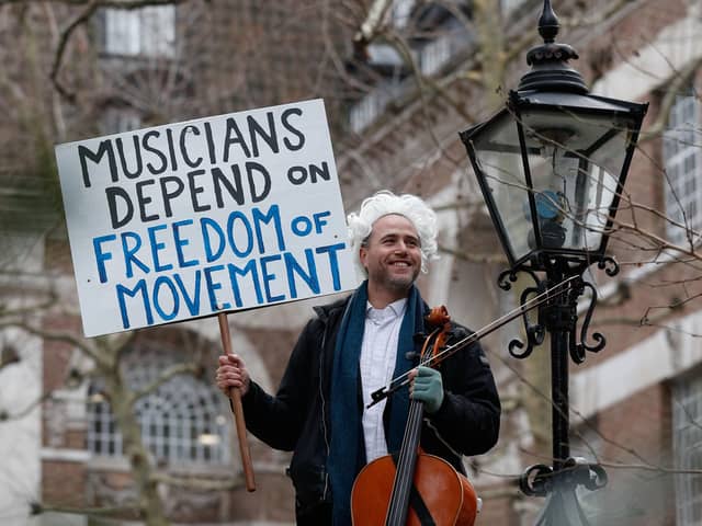 British-German musician Simon Wallfisch poses with his cello outside Europe House in London on January 10, 2019 before his monthly musical performance to protest against Britain's exit from the European Union.