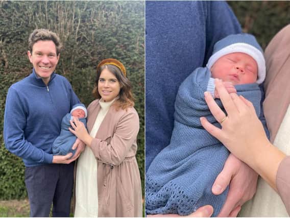 The couple are pictured smiling with their first child, in an image released by Buckingham Palace