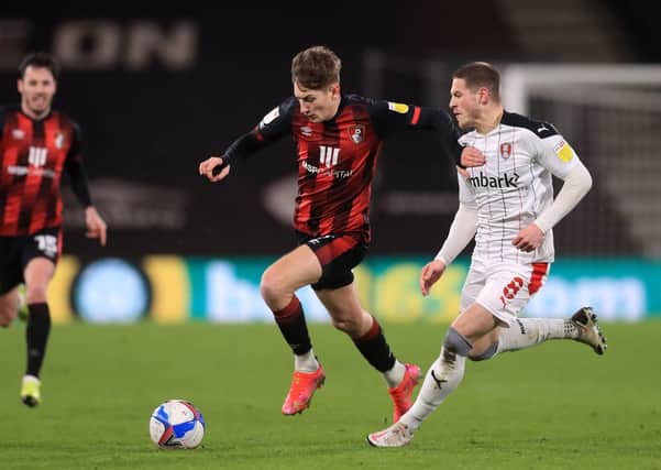 TOUGH TO TAKE: Bournemouth's David Brooks (left) and Rotherham United's Ben Wiles battle for the ball during the midweek Championship clash on the south coast, the hosts' winning 1-0. Picture: PA.