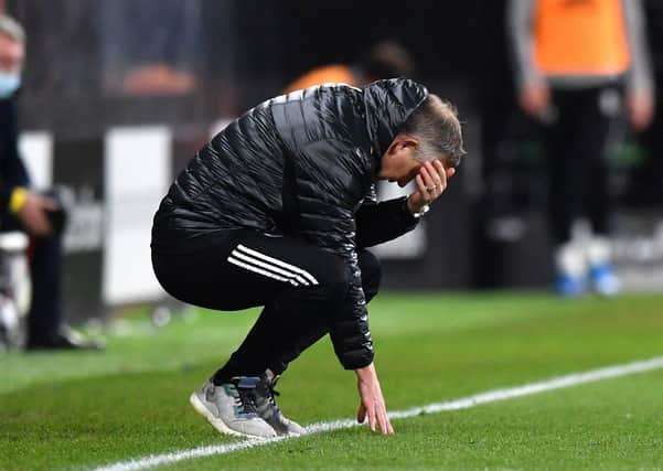 AGONY: Sheffield United manager Chris Wilder crouches in frustration at Craven Cottage. Picture: Ben Stansall/PA