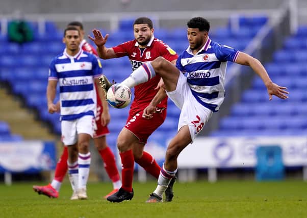 Challenge: Reading's Josh Laurent  and Middlesbrough's Sam Morsy battle for the ball.