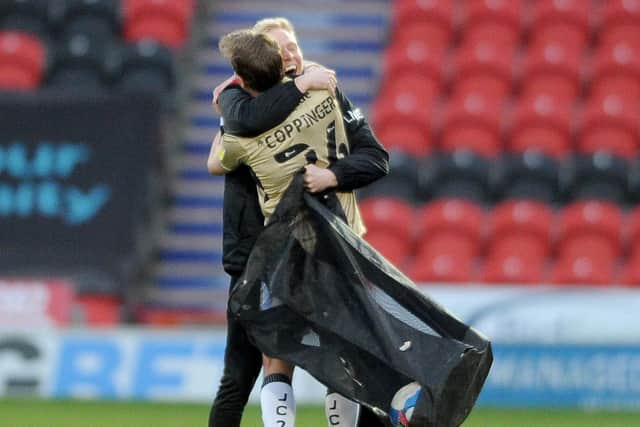 Hug: James Coppinger is congratulated at the end of the match. Picture: Simon Hulme