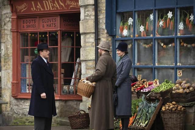 Tristan (Callum Woodhouse), Siegfried (Samuel West) and Mrs Hall (Anna Madeley) in Grassington, which serves as Darrowby in All Creatures Great and Small. The locations team thanked the local people for their help in transforming it to 1930s Yorkshire.