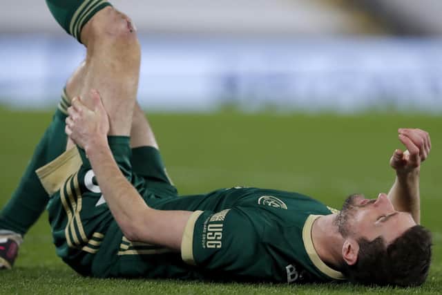 Down: Sheffield United's Chris Basham lies injured before he is substituted.