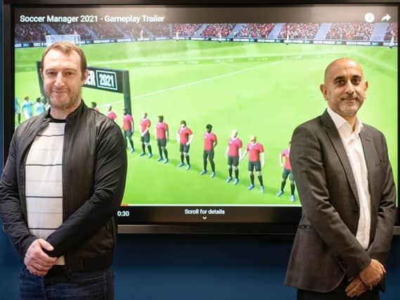 Pictured (L to R) are Soccer Manager co founder and managing director, Andy Gore and Garbutt + Elliott partner, Tariq Javaid, with Soccer manager on screen in the background.
