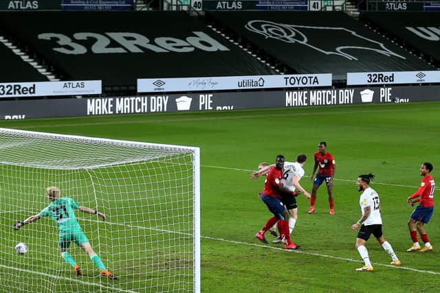 Derby County's George Edmundson scores their side's first goal against Huddersfield (Picture: PA)