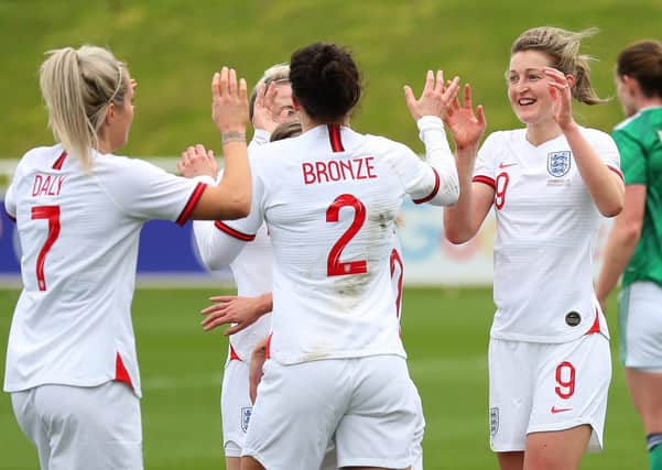 Ellen White of England celebrates with Rachel Daly and Lucy Bronze after scoring their team's second goal. Picture: PA